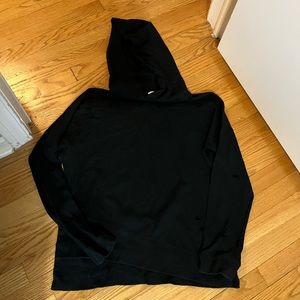 Black soft hoody sweatshirt with little holes cut out throughout the sweatshirt